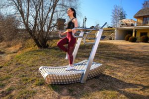 a woman exercises on the iGreenMill outdoor treadmill