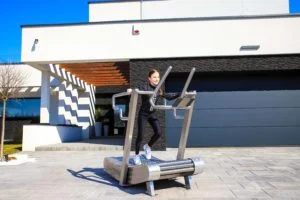 the girl walks on an outdoor treadmill 2nd image