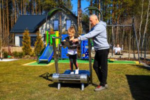 An elderly man exercises on an outdoor treadmill