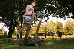 A man practices walking on the GreenMill City outdoor treadmill in the park